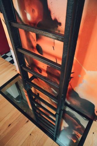 a book shelf with a painting on the side of it at Den Alen Arbed's Büro in Kayl