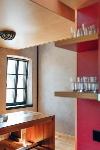 a kitchen with wooden shelves and a window at Den Alen Arbed's Büro in Kayl