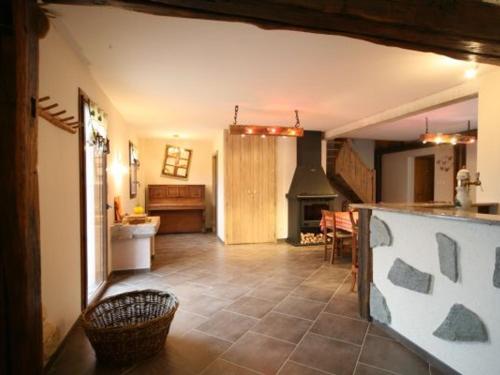 a living room with a kitchen and a stove at Gîte spacieux, confort moderne, 8 pers, terrasse privative, animaux admis, WiFi - FR-1-589-227 in Vagney