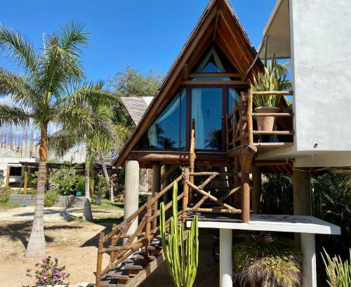 a tree house on the beach with a balcony at A&V Hotel Boutique in Acapulco