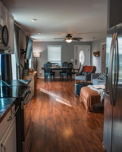 a kitchen and a living room with a table at Sandusky Bay Hot Tub, Gym, Patio, Games, Recreation Watercraft, Waterside Home, check it out! in Port Clinton