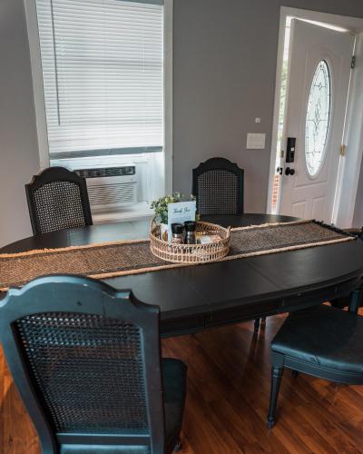 a dining room table with chairs and a counter top at Sandusky Bay Hot Tub, Gym, Patio, Games, Recreation Watercraft, Waterside Home, check it out! in Port Clinton