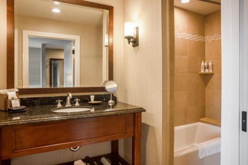 a bathroom with a sink and a tub and a mirror at The Lodge at Bodega Bay in Bodega Bay