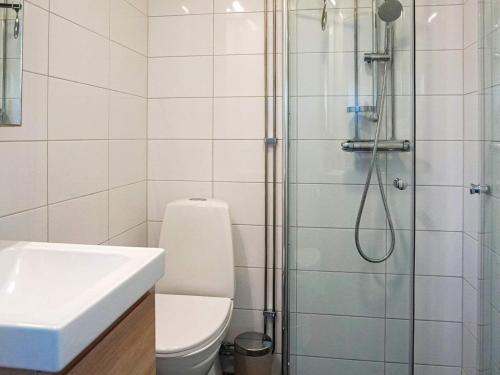 a bathroom with a shower and a toilet and a sink at Holiday home SÖLVESBORG XVI in Sölvesborg