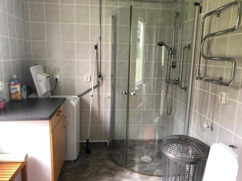 a bathroom with a shower with a glass door at Holiday home KROKOM 