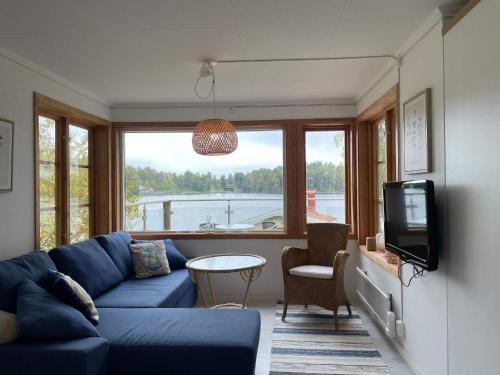 a living room with a blue couch and a tv at 4 person holiday home in BENGTSFORS-By Traum in Bengtsfors