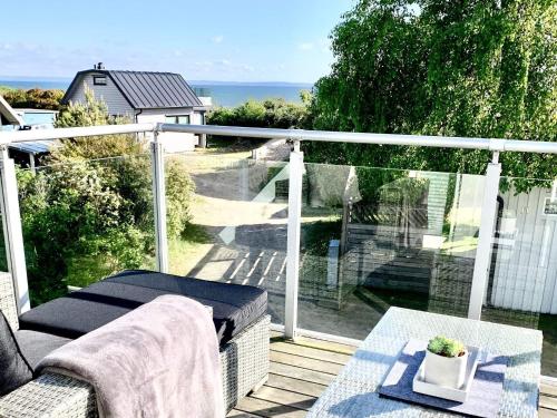 a balcony with a table and a view of the ocean at 6 person holiday home in HALMSTAD-By Traum in Halmstad
