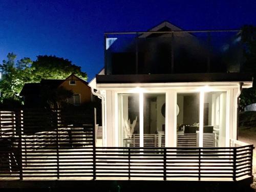 a white house with a fence in front of it at 6 person holiday home in HALMSTAD-By Traum in Halmstad