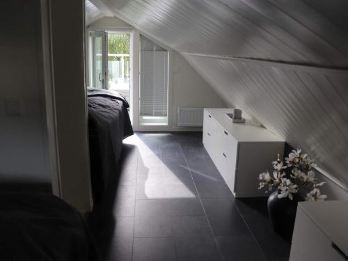 a bedroom with a bed and a dresser and a window at 6 person holiday home in HALMSTAD-By Traum in Halmstad