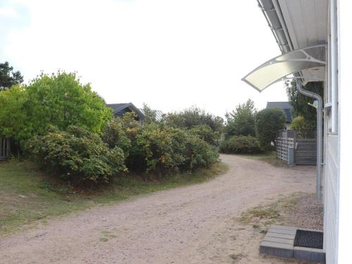 a dirt road next to a house with a street light at 6 person holiday home in HALMSTAD-By Traum in Halmstad