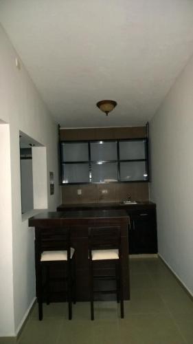 a dining room with a table and two chairs at Hotel Bugambilias in Ciudad Obregón
