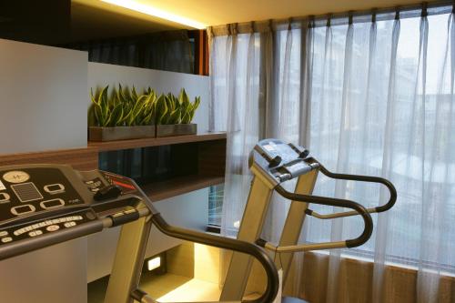 a room with a treadmill and a window at In One City Inn in Taichung