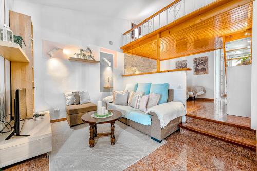 a living room with a couch and a table at Bungalow Canarios 1 ,Arguineguín in Arguineguín