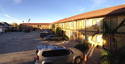 a car parked in a parking lot next to a motel at Fullerton Inn in Fullerton