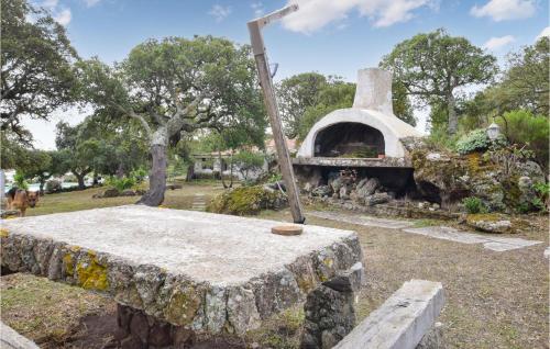 a stone table with a stone oven in a park at Gorgeous Home In Sedini With Wifi in Sedini