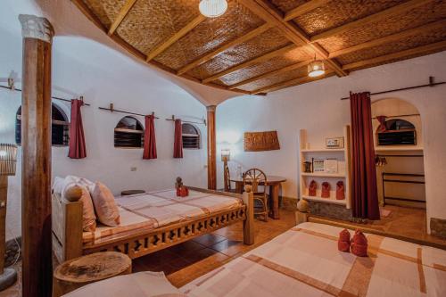 a bedroom with a bed and a table in a room at Atremaru Jungle Retreat in Puerto Princesa City