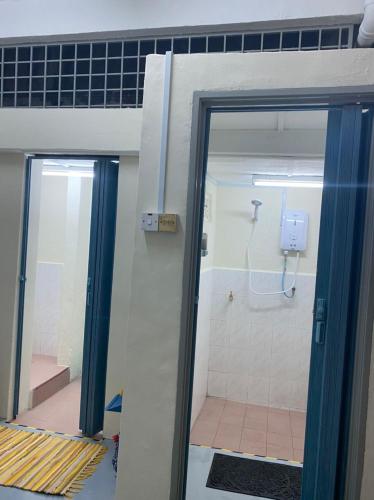 a bathroom with a shower and a glass door at JAVA 6 HOME 5 min to Jonker in Malacca
