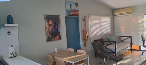 a living room with a table and chairs and a couch at Lugo`s guest room in Punta Cana