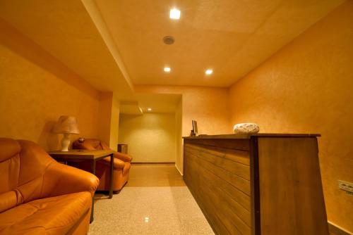 a living room with a couch and a table at Bucium Motel & SPA in Iaşi