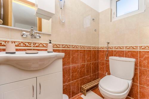a bathroom with a toilet and a sink at House Hacienda in Tribunj