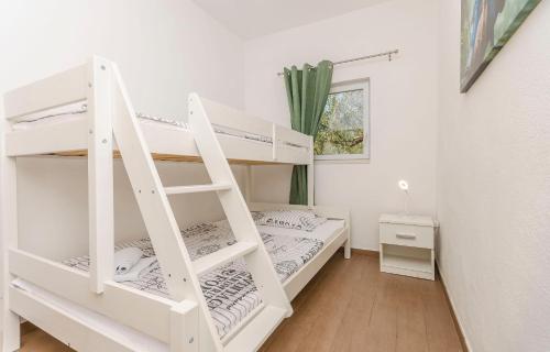 a room with two bunk beds and a ladder at House Hacienda in Tribunj