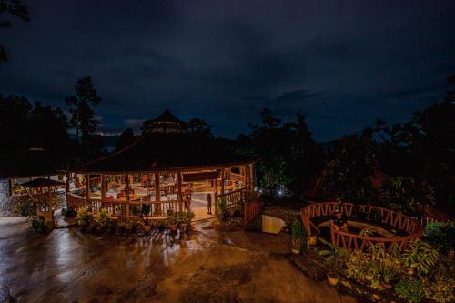 a building with tables and chairs at night at Atremaru Jungle Retreat in Puerto Princesa City