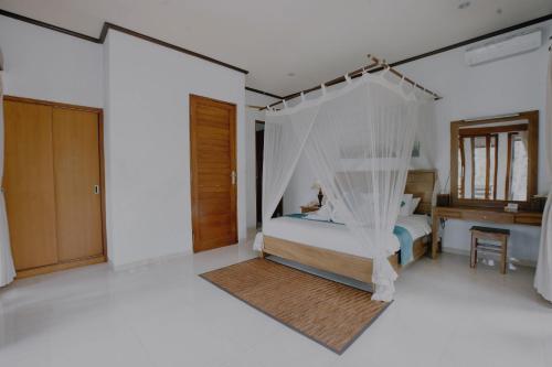 Postel nebo postele na pokoji v ubytování Budhi Ayu Villas and Cottages Ubud by Mahaputra-CHSE Certified
