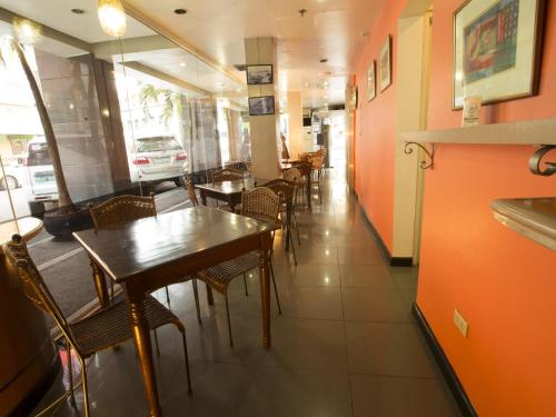 a dining room with tables and chairs in a restaurant at Harbor Town Hotel in Iloilo City