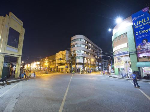 an empty street in a city at night at Harbor Town Hotel in Iloilo City