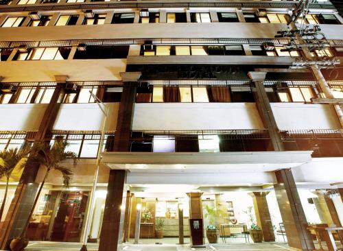 a tall building with a lot of windows at Harbor Town Hotel in Iloilo City