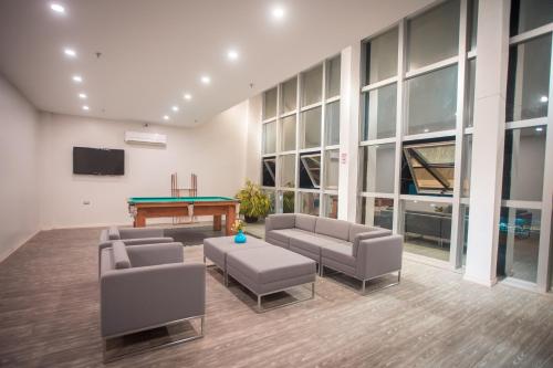 a room with couches and a pool table in a building at Uno Hotel in Carpina