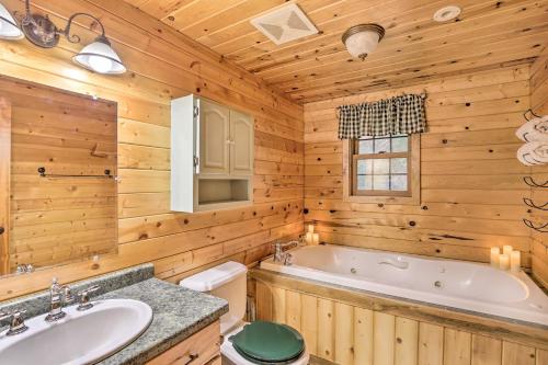 a log cabin bathroom with a tub and a sink at Splendid Family Cabin with Hot Tub and Grill! in Lake City