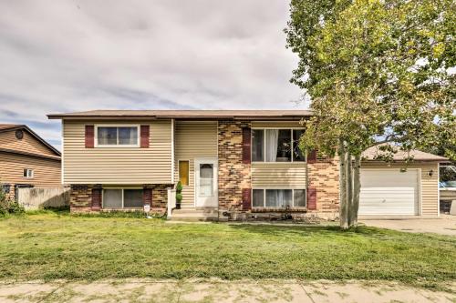 a house with a tree in front of it at Deck and Yard Pet-Friendly Apartment in Magna! in West Valley City
