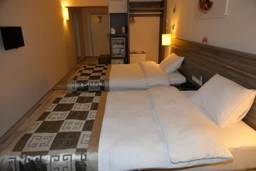 Postel nebo postele na pokoji v ubytování Enar Hotel