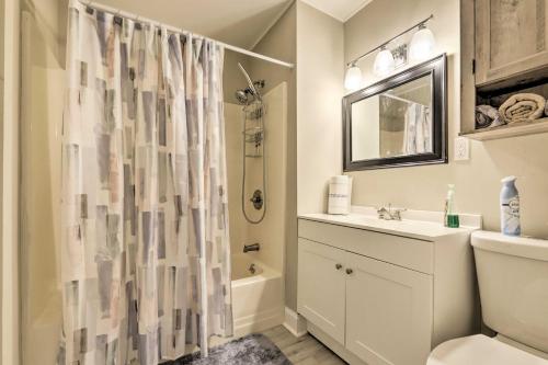 a bathroom with a shower curtain and a sink at Cozy Springfield Apartment, Close to Parks! in Springfield