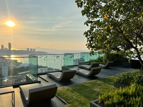 a balcony with couches and a view of the city at Secret Gem Sea-View King Size EDGE Central Pattaya in Pattaya Central
