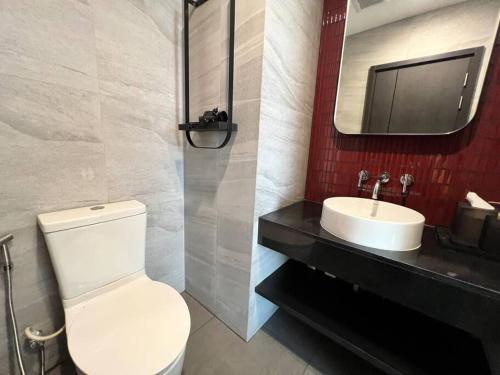 a bathroom with a white toilet and a sink at Secret Gem Sea-View King Size EDGE Central Pattaya in Pattaya Central