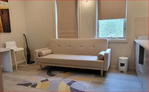 a living room with a couch and a window at Newly built cozy double storey 3 bed room house at Prospect. in Prospect