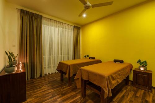 two beds in a room with yellow walls at Morning Dew Boutique Hotel Ella in Ella