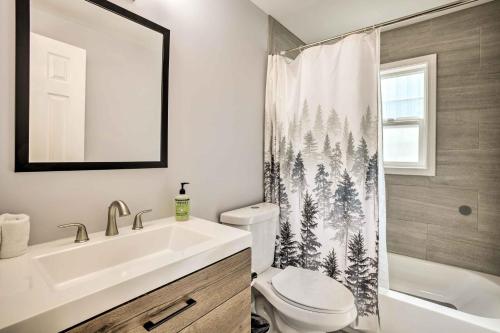 a bathroom with a sink and a toilet and a shower curtain at Historic Casper Retreat with Renovated Yard! in Casper