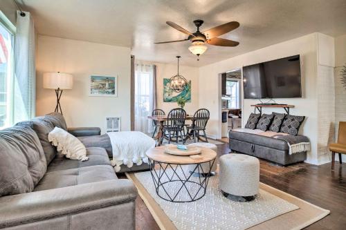 a living room with a couch and a table at Charming Seaview Home with BBQ, Deck and Fire Pit in Seaview