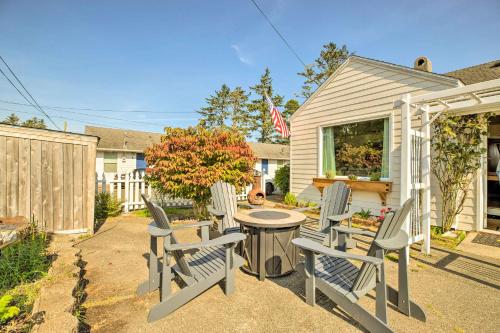 a patio with chairs and a table in a backyard at Charming Seaview Home with BBQ, Deck and Fire Pit in Seaview