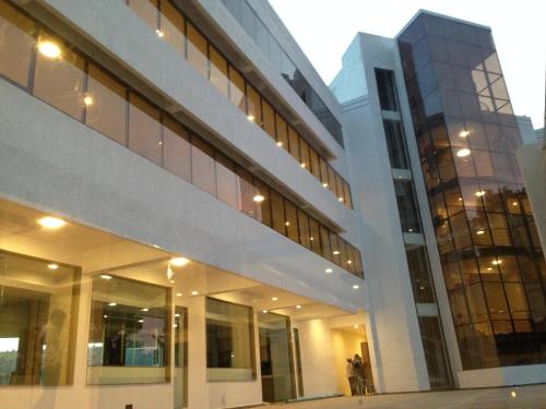 a large building with many windows in a city at Hotel Lake View in Saputara