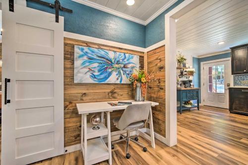 a home office with a desk and a painting on the wall at Modern Broken Bow Cabin, Near Lake and Wineries in Broken Bow