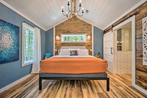 1 dormitorio con cama y lámpara de araña en Modern Broken Bow Cabin, Near Lake and Wineries, en Broken Bow