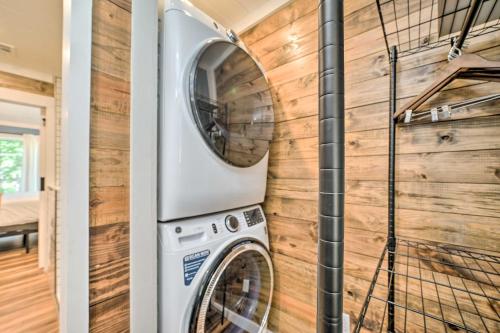 a washer and dryer in a room with a wooden wall at Modern Broken Bow Cabin, Near Lake and Wineries in Broken Bow