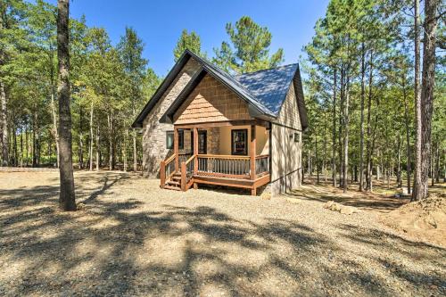 a small cabin in the middle of a forest at Modern Broken Bow Cabin, Near Lake and Wineries in Broken Bow