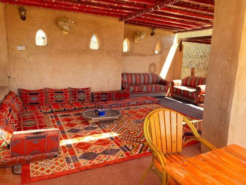a living room with a couch and a table at Bait Aljabal Hospitality Inn in Al Ḩamrāʼ