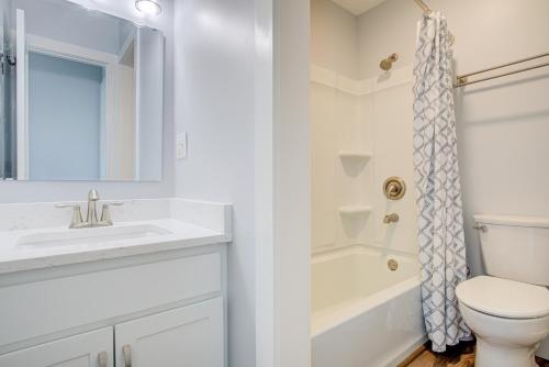 a white bathroom with a sink and a toilet at Topsail Villa 24 in North Topsail Beach
