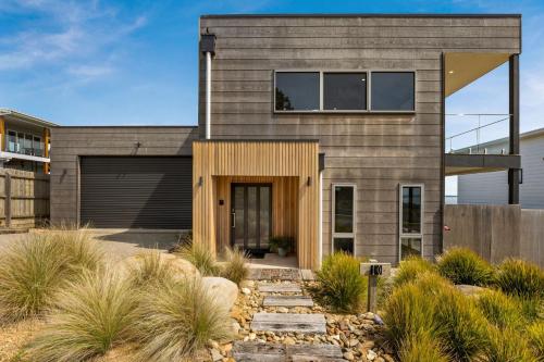a house in the desert with a wooden facade at La Calma in San Remo